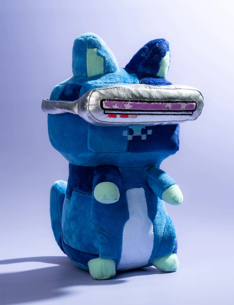 Photograph of the Midnight MoonCat plushie; a blue, tortie-patterned, smiling MoonCat